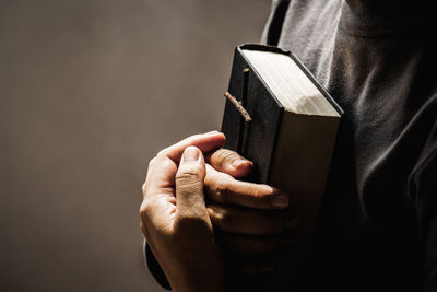 Close-up of hand holding book