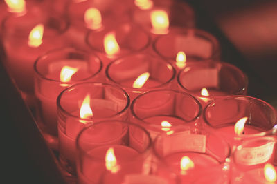 Close-up of illuminated candles at temple