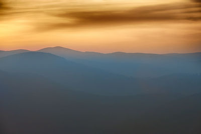 Scenic view of mountains against sky during sunset