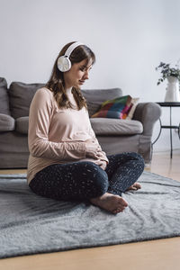 Woman sitting on sofa at home