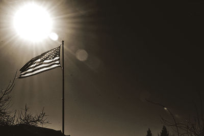 Low angle view of illuminated street light against sky on sunny day