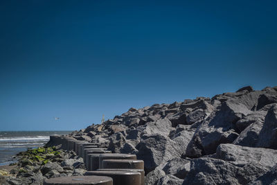 Scenic view of sea against clear blue sky