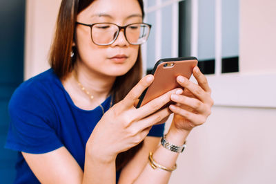 Midsection of woman using mobile phone