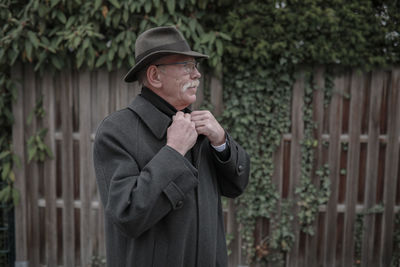 Man looking away while standing outdoors