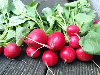 Radishes on wooden plank