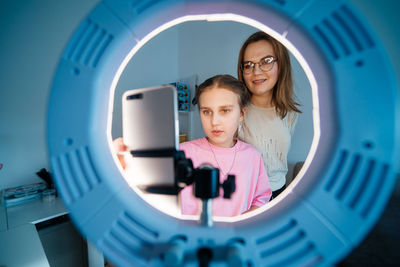 Mother and daughter record video use smartphone