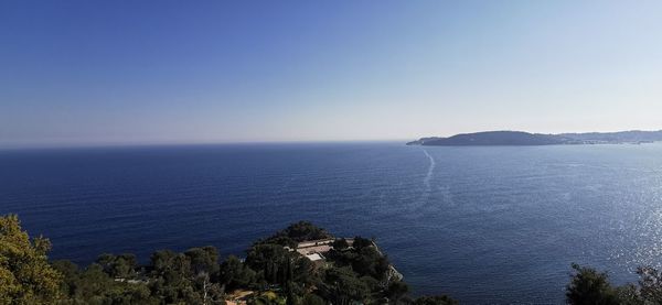 Scenic view of sea against clear blue sky