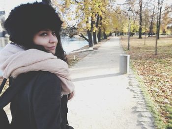 Portrait of young woman standing in autumn