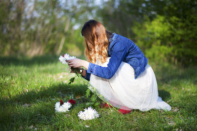 Young woman standing on grass