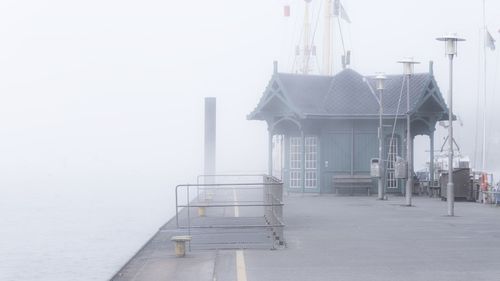 Pier over river in foggy weather