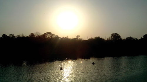 Scenic view of lake at sunset