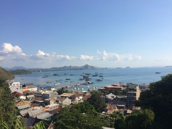 High angle view of city by sea against sky
