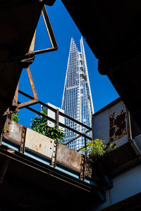 Low angle view of buildings against blue sky