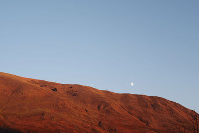 Low angle view of mountain against clear blue sky