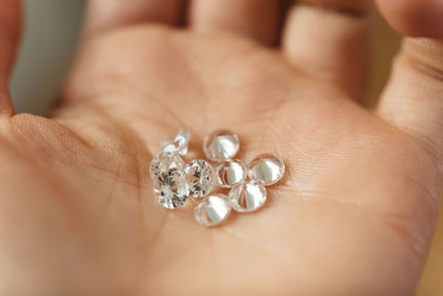 Close-up of hand holding diamonds