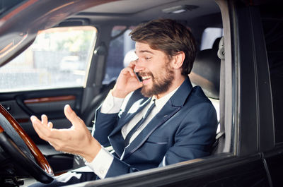 Man using mobile phone while sitting in car