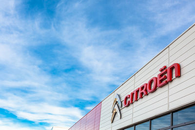 Low angle view of information sign against blue sky