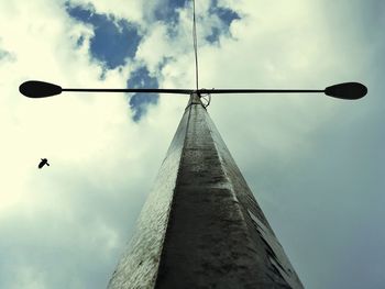 Low angle view of street light against cloudy sky