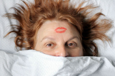 Portrait of woman lying down on bed