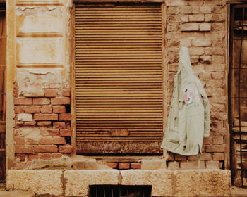 Close-up of clothes hanging on brick wall