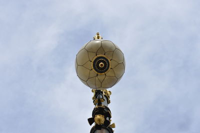 Low angle view of cross against sky