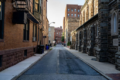 Empty alley amidst buildings in city