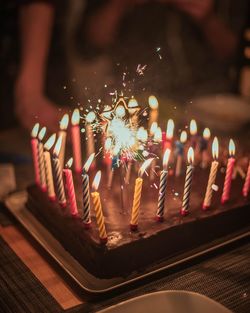 View of burning candles on birthday cake