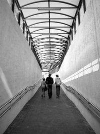 Rear view of people walking in corridor