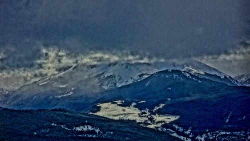 Scenic view of snowcapped mountains against sky