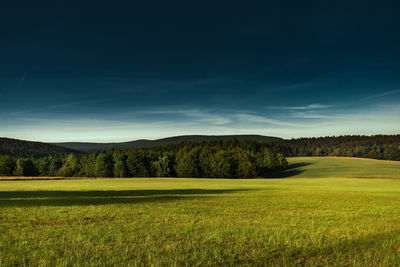 Scenic view of golf course against sky