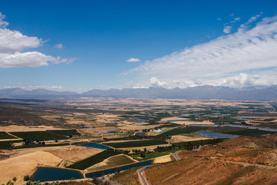 Aerial view of agricultural field against blue sky