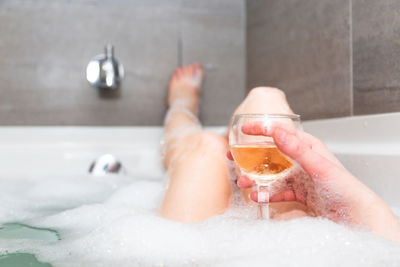 Midsection of woman in bathroom at home