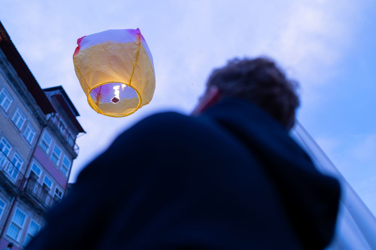 LOW ANGLE VIEW OF PEOPLE IN MID-AIR