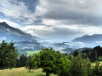 Scenic view of mountains against cloudy sky