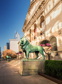 Statue in city against clear sky