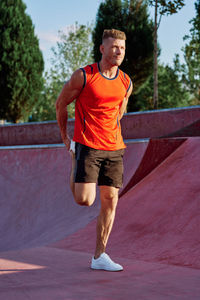 Full length of young man exercising on road