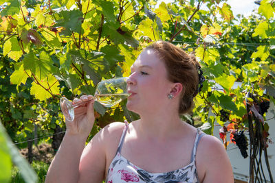 Portrait of senior woman against plants