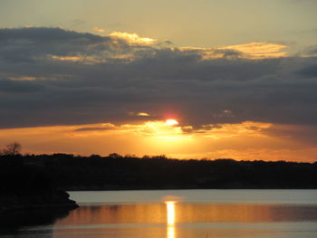 Scenic view of lake against orange sky