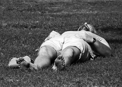 Midsection of man lying down on land