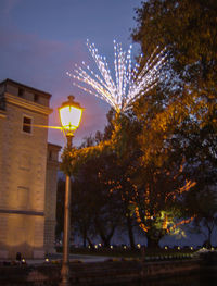 Low angle view of illuminated street light at night