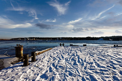 Scenic view of lake against sky during winter