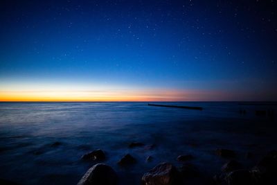 Scenic view of sea against sky at night