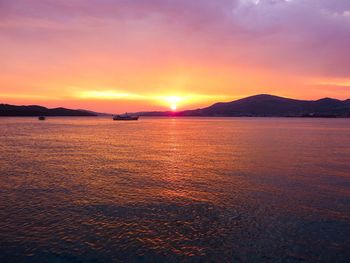 Scenic view of sea against romantic sky at sunset