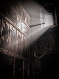 Low angle view of illuminated window in abandoned building