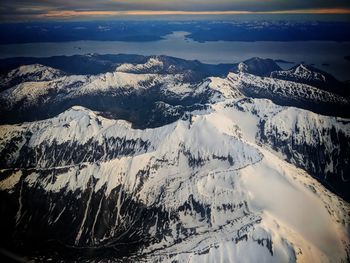 Aerial view of snowcapped mountains against sky