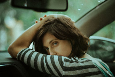 Portrait of woman sitting in car