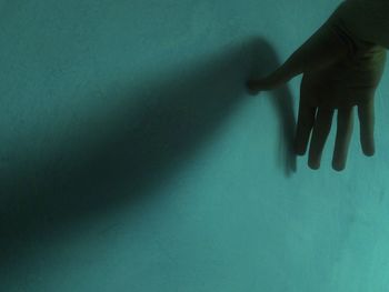 Low section of woman with shadow on wall