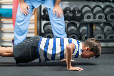 Low section of woman exercising in gym