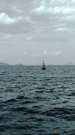 Boat sailing in sea against sky