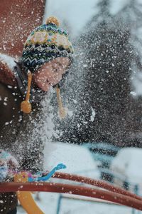 Person holding ice cream cone during winter